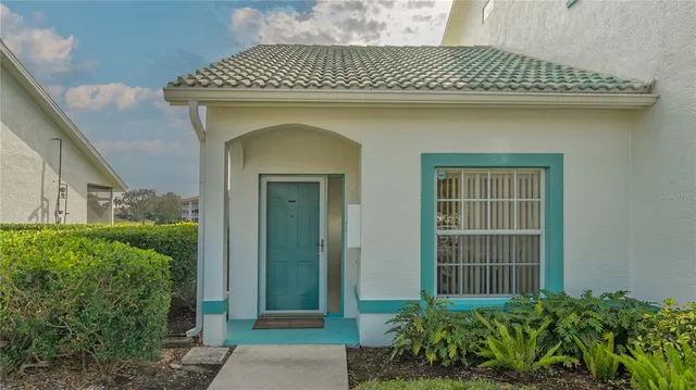 a front view of a house with a lots of plants