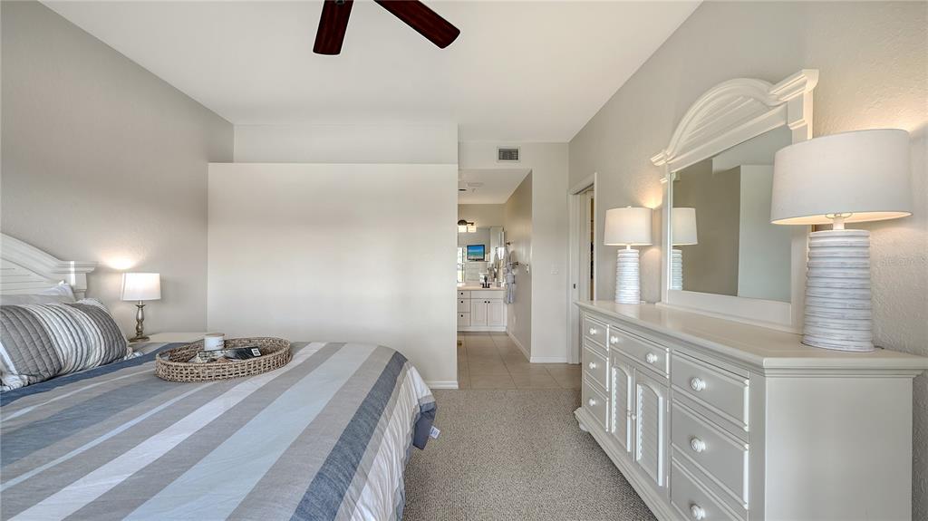 6556 Fairway Gardens Drive Bradenton, FL 34203 - Photo 14 of 43 a bedroom with a bed and a chandelier