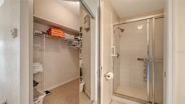 a bathroom with a glass shower door