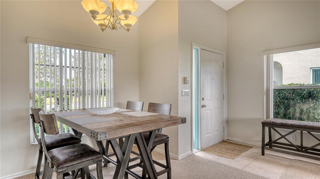 6556 Fairway Gardens Drive Bradenton, FL 34203 - Photo 3 of 43 a view of a dining room with furniture window and wooden floor