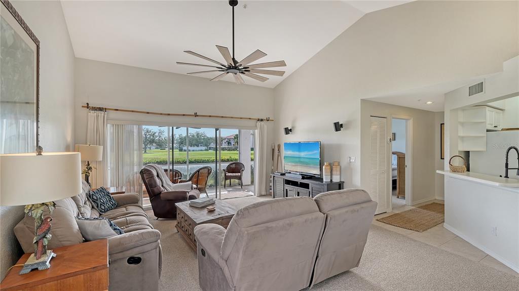 6556 Fairway Gardens Drive Bradenton, FL 34203 - Photo 4 of 43 a living room with furniture a large window with ceiling fan