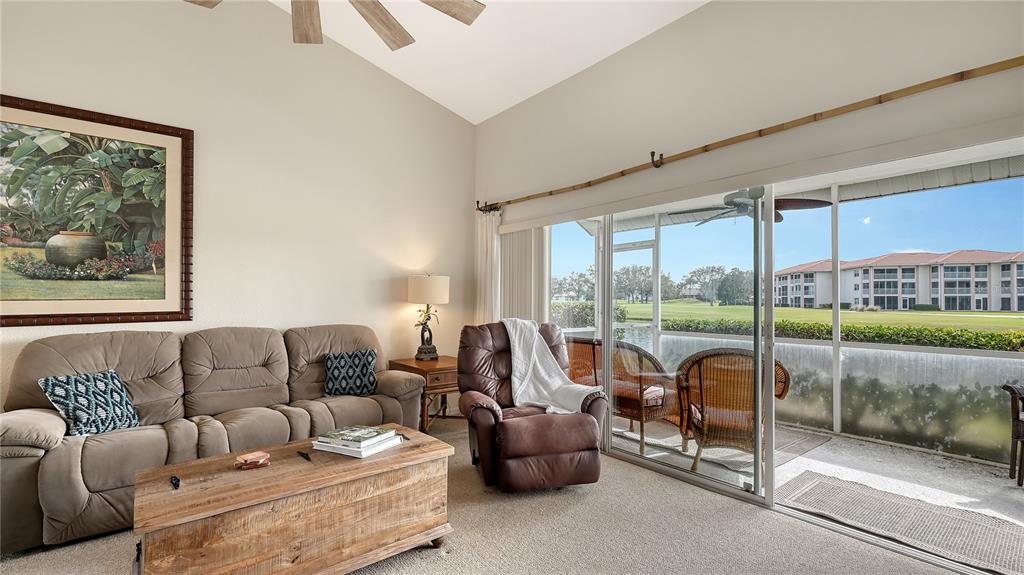 6556 Fairway Gardens Drive Bradenton, FL 34203 - Photo 5 of 43 a living room with furniture and a floor to ceiling window
