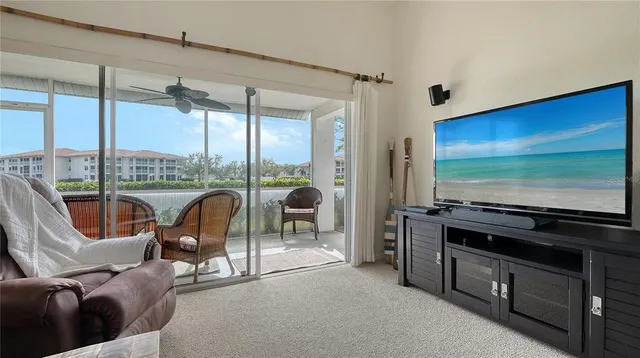 a living room with furniture tv and large window