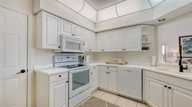 a kitchen with cabinets appliances a sink and a counter top