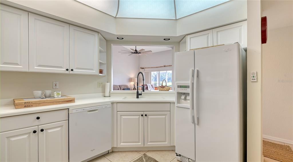 6556 Fairway Gardens Drive Bradenton, FL 34203 - Photo 9 of 43 a kitchen with white cabinets and white appliances