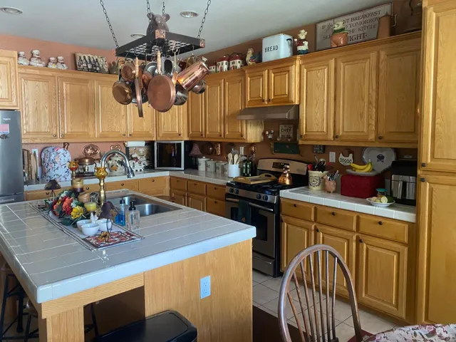 a kitchen with a table chairs and a stove