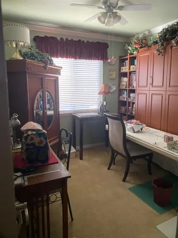 a room with a table chairs and a workspace