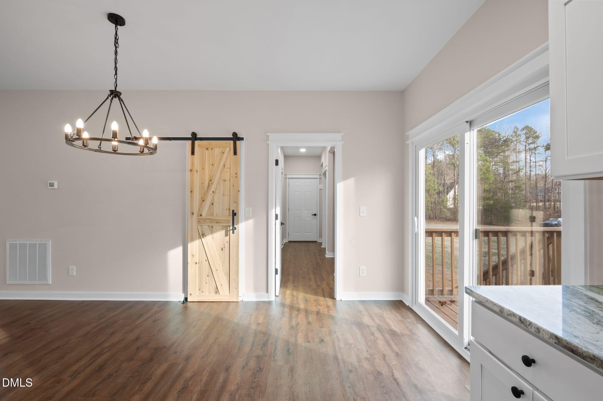 193 Community House Road, Unit A47 266 Roxboro, NC 27574 - Photo 36 of 55 a view of an empty room with wooden floor and a window