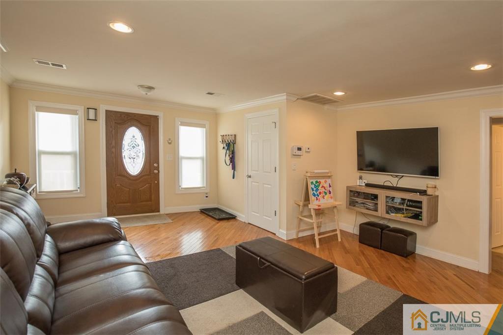 28 Fox Road Edison, NJ 08817 - Photo 8 of 25 a living room with furniture and a flat screen tv