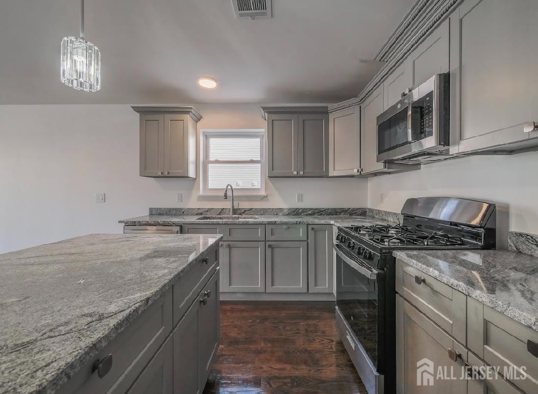 496 South 18th Street, Unit 2 Newark, NJ 07103 - Photo 11 of 15 a kitchen with stainless steel appliances granite countertop a sink stove and microwave