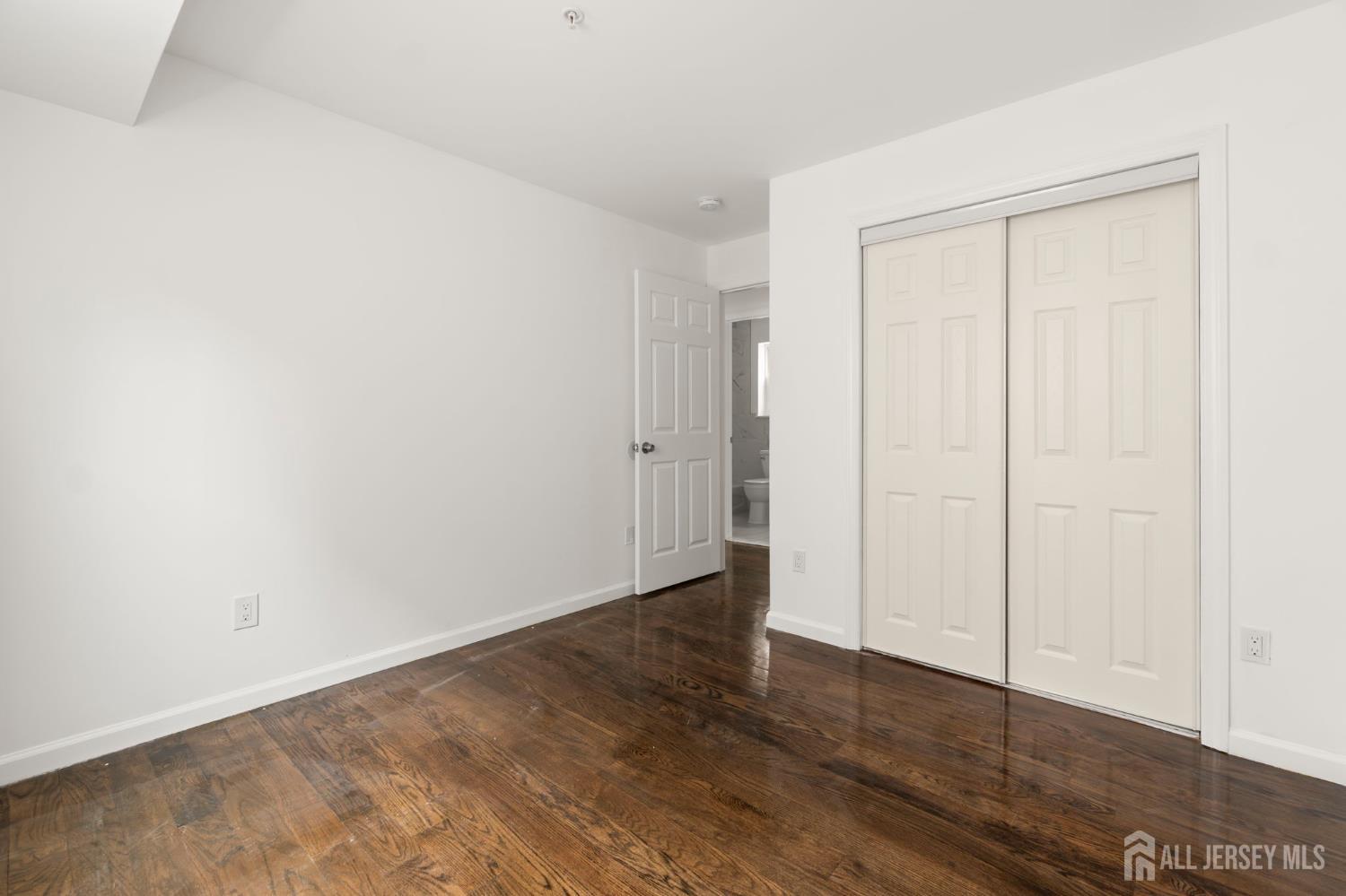 496 South 18th Street, Unit 2 Newark, NJ 07103 - Photo 12 of 21 a view of an empty room with wooden floor
