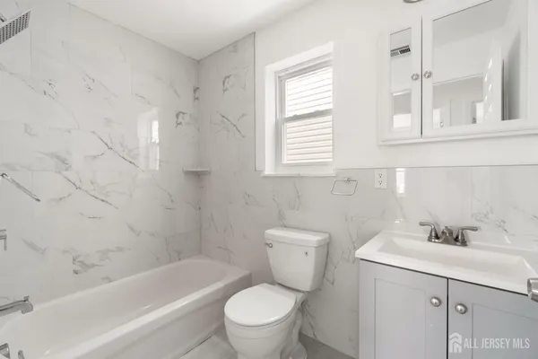 a bathroom with a sink toilet and bathtub