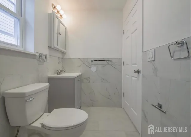 a white toilet sitting next to a bathroom sink