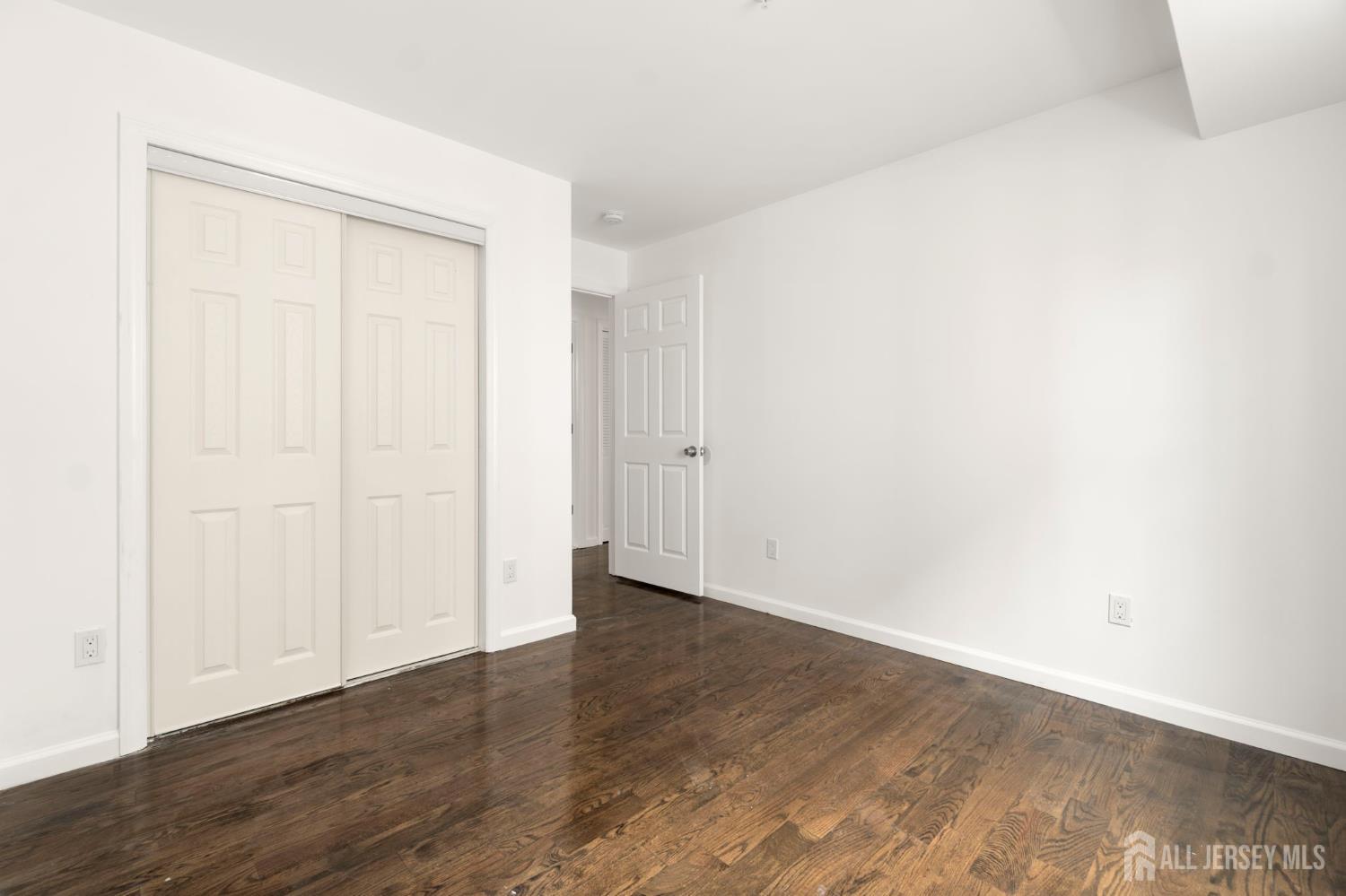 496 South 18th Street, Unit 2 Newark, NJ 07103 - Photo 15 of 21 a view of an empty room with wooden floor