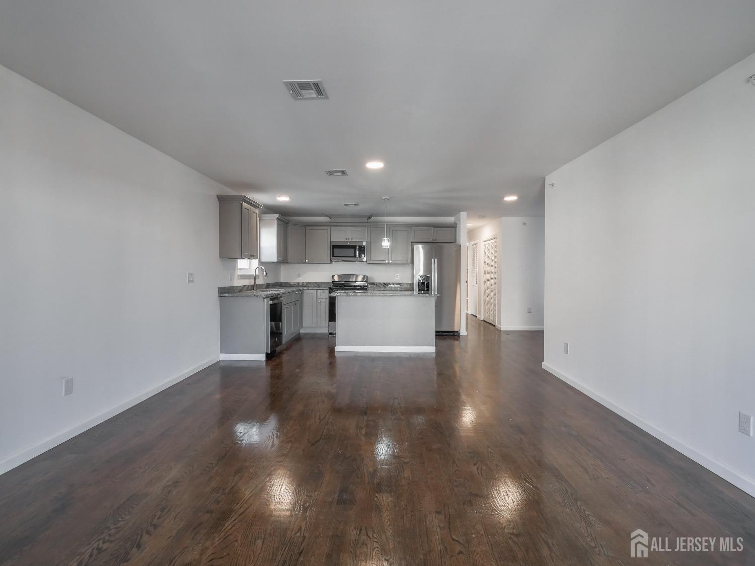 496 South 18th Street, Unit 2 Newark, NJ 07103 - Photo 3 of 15 a view of a kitchen with cabinets and wooden floor