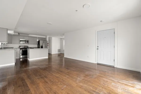 a view of a kitchen with microwave and cabinets