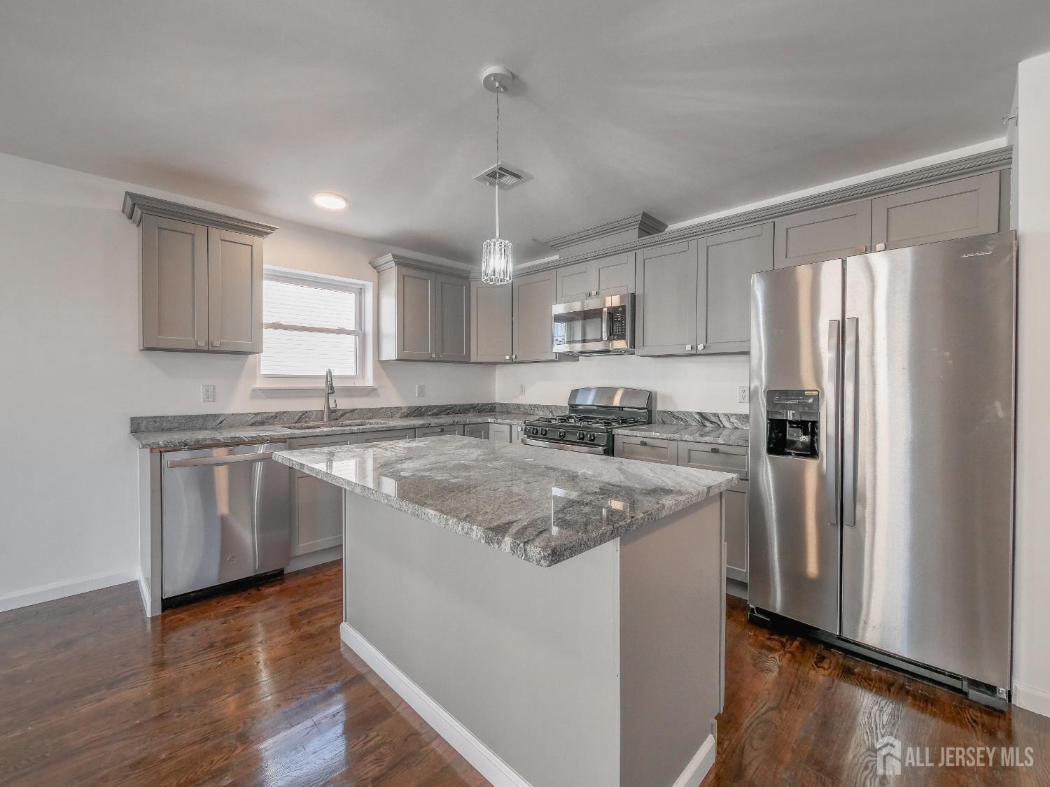 496 South 18th Street, Unit 2 Newark, NJ 07103 - Photo 8 of 15 a kitchen with stainless steel appliances granite countertop a refrigerator a sink dishwasher a stove top oven a refrigerator and white cabinets with wooden floor