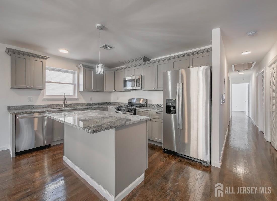 496 South 18th Street, Unit 2 Newark, NJ 07103 - Photo 9 of 15 a kitchen with stainless steel appliances granite countertop a refrigerator a sink dishwasher a stove and white countertops with wooden floor