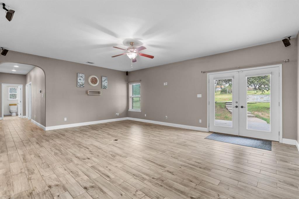 217 Naibara Trail Weatherford, TX 76088 - Photo 11 of 40 an empty room with wooden floor and windows