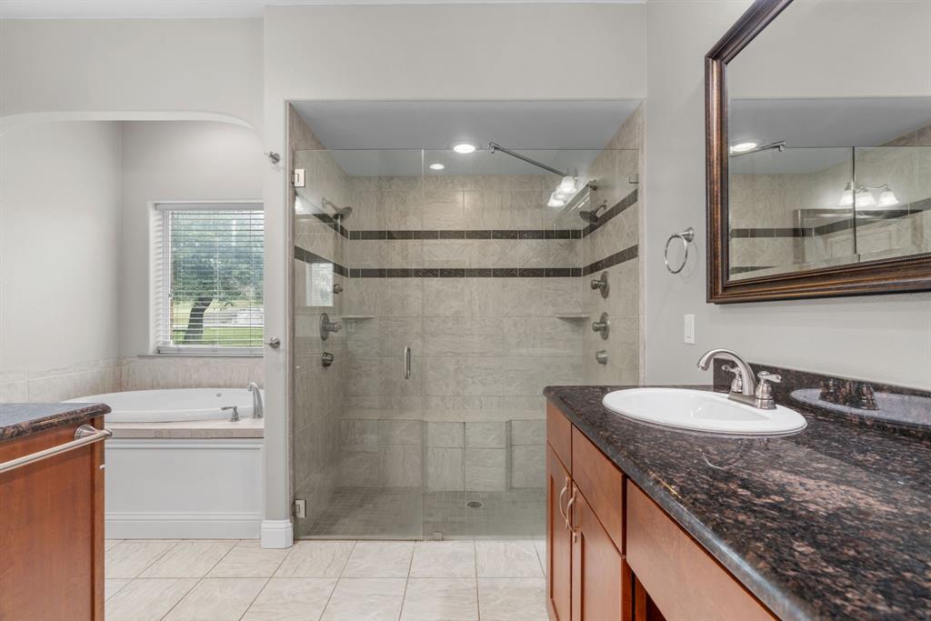 217 Naibara Trail Weatherford, TX 76088 - Photo 15 of 35 a bathroom with a granite countertop sink a toilet and shower