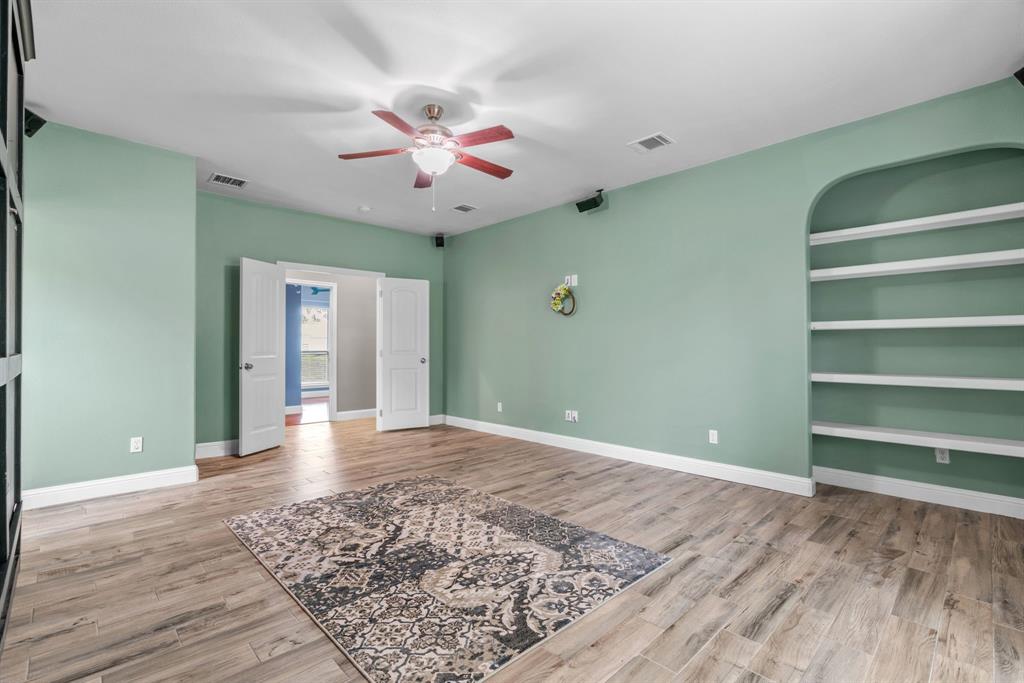 217 Naibara Trail Weatherford, TX 76088 - Photo 17 of 35 a view of an empty room with a window and wooden floor