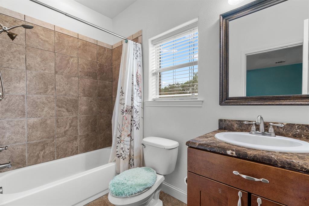 217 Naibara Trail Weatherford, TX 76088 - Photo 19 of 40 a bathroom with a granite countertop sink toilet and shower