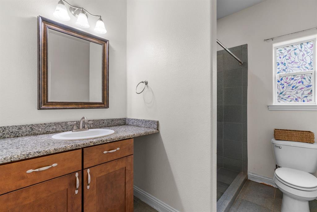 217 Naibara Trail Weatherford, TX 76088 - Photo 20 of 40 a bathroom with a granite countertop toilet sink and mirror