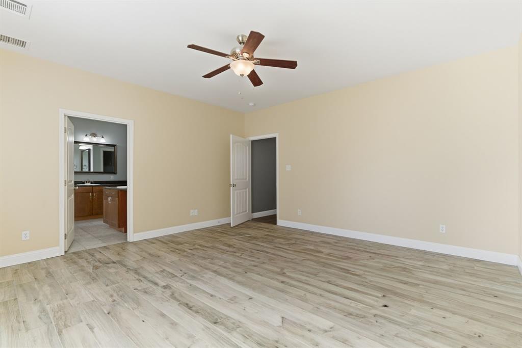 217 Naibara Trail Weatherford, TX 76088 - Photo 23 of 40 a view of empty room with wooden floor and ceiling fan