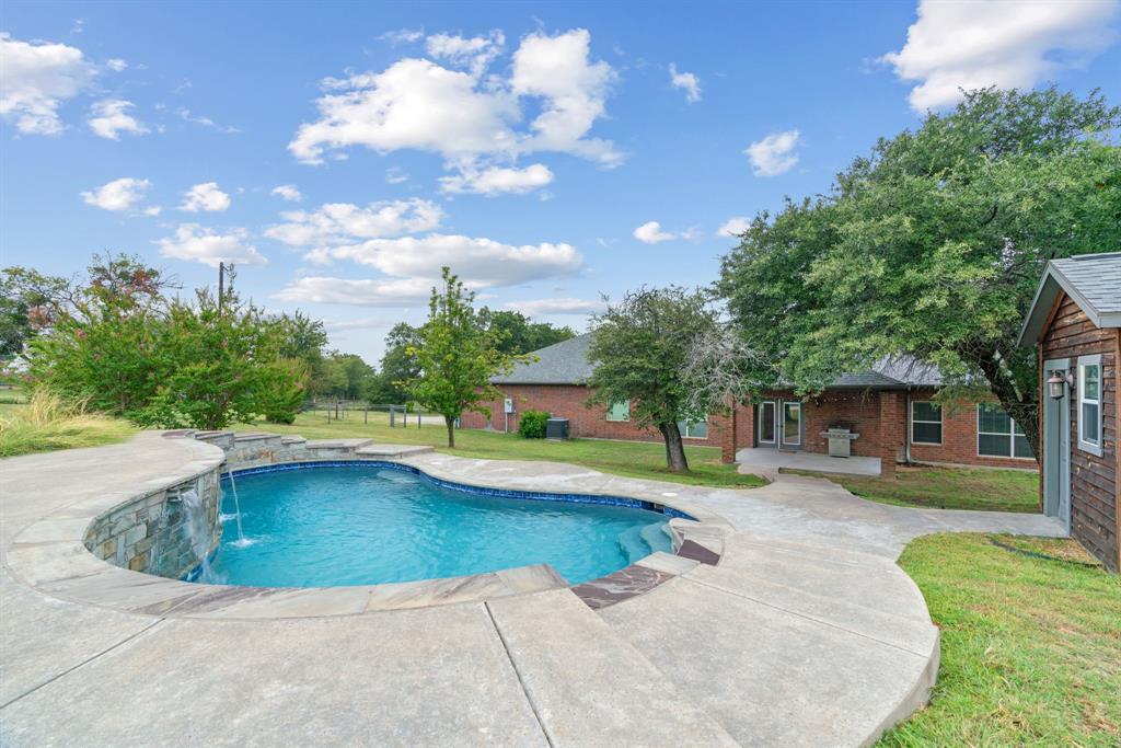 217 Naibara Trail Weatherford, TX 76088 - Photo 29 of 40 a view of a house with swimming pool and a yard