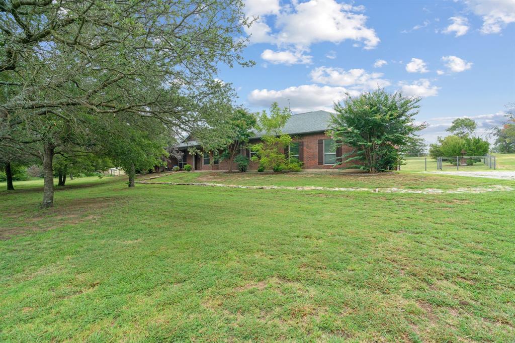 217 Naibara Trail Weatherford, TX 76088 - Photo 3 of 35 a backyard of a house with lots of green space and fountain