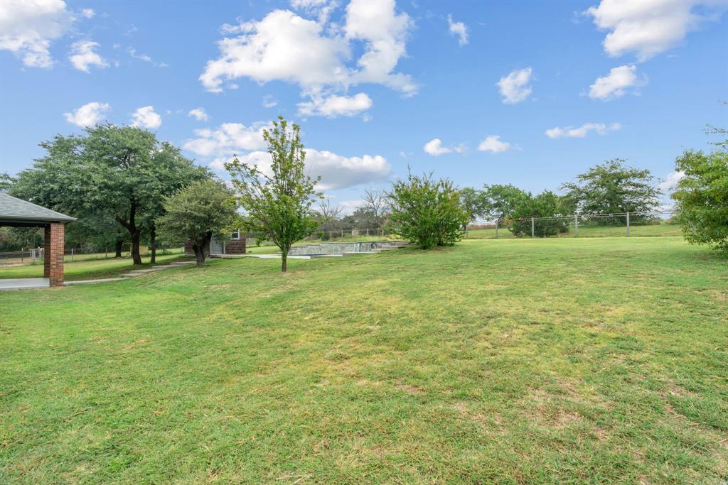 217 Naibara Trail Weatherford, TX 76088 - Photo 33 of 40 a view of a green field with trees in the background