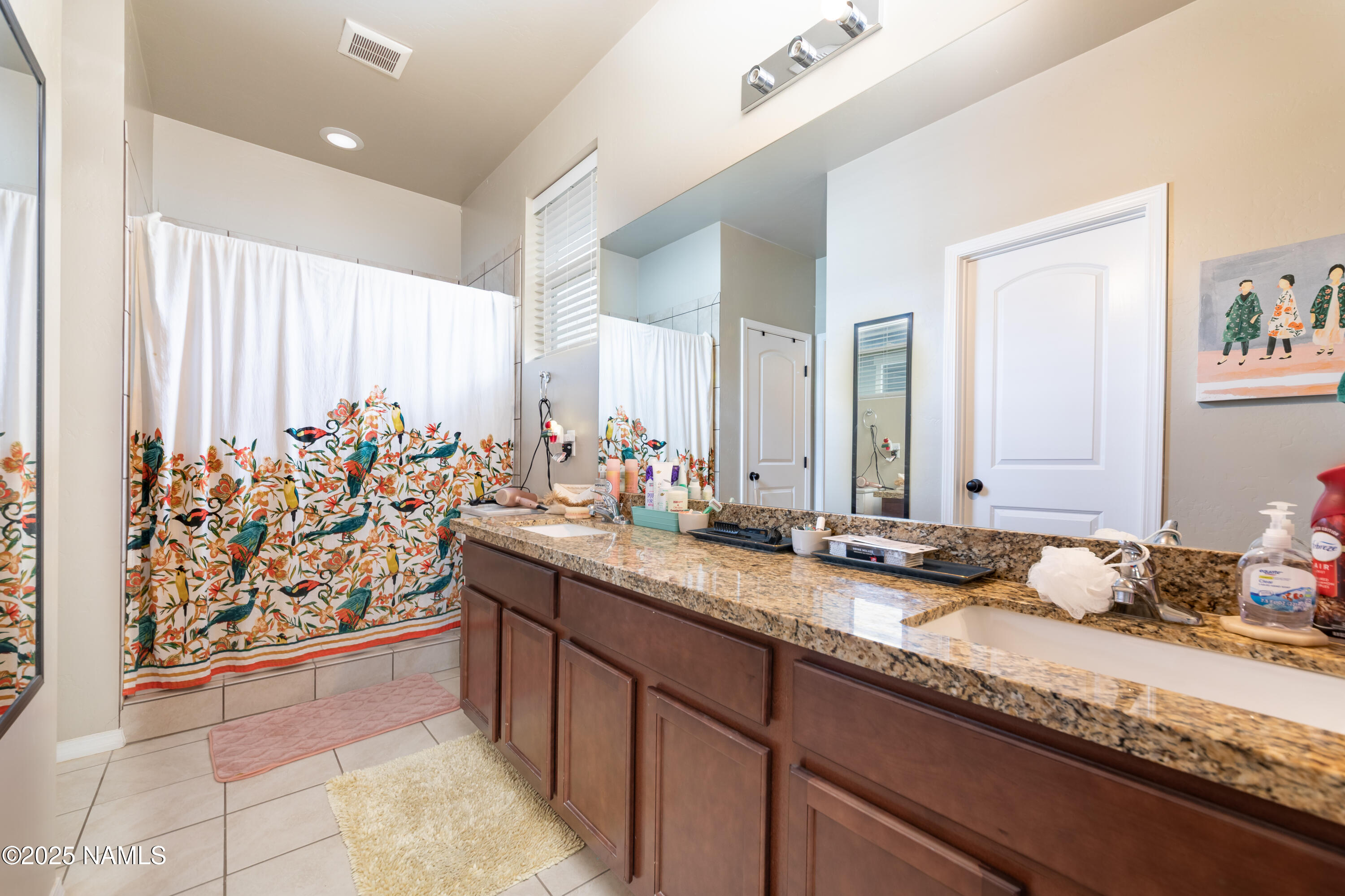 4500 Centaurus Road Bellemont, AZ 86015 - Photo 11 of 20 a bathroom with a granite countertop sink and a mirror