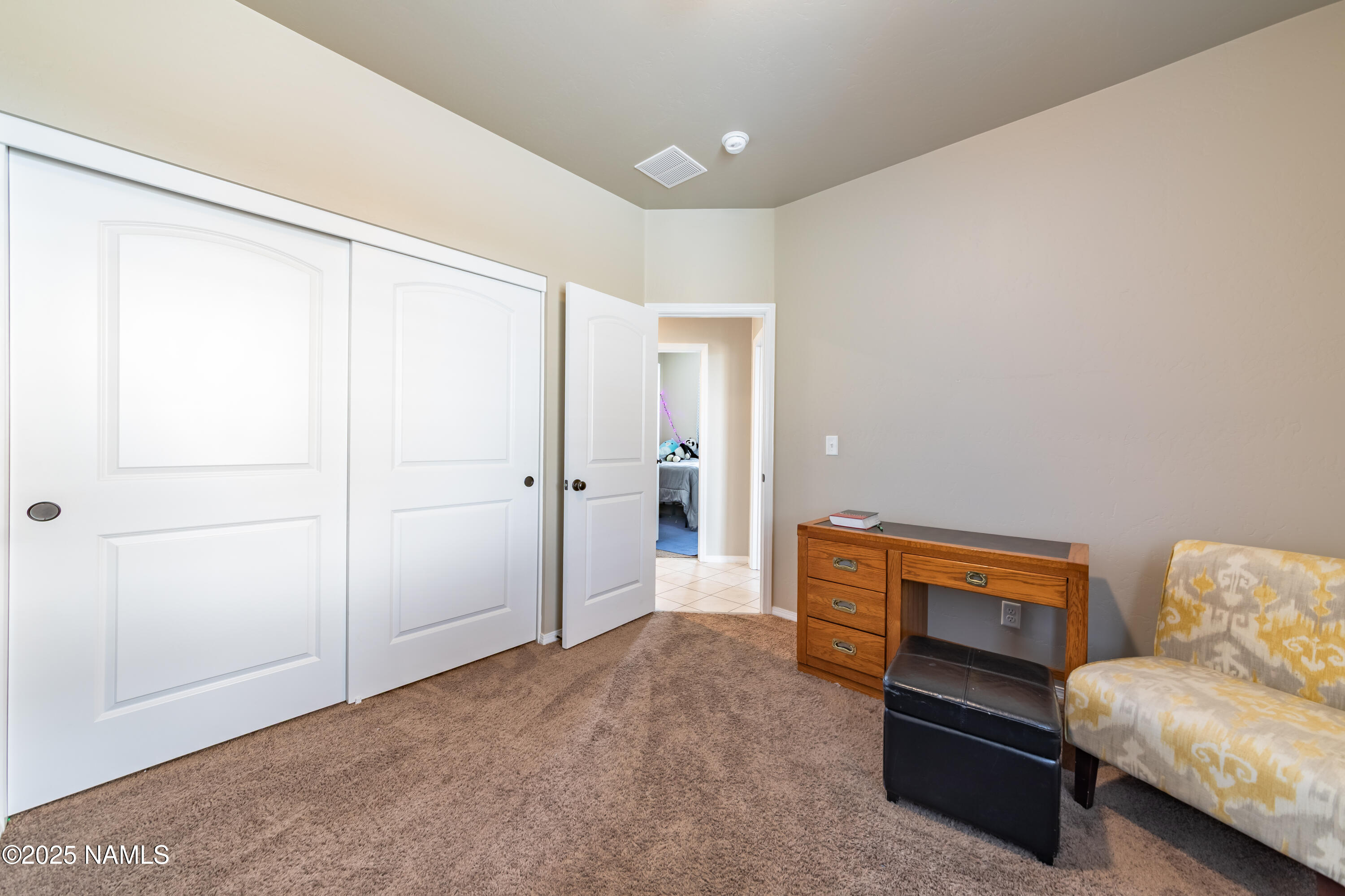 4500 Centaurus Road Bellemont, AZ 86015 - Photo 13 of 20 a hallway with a couch and a dresser with wooden floor