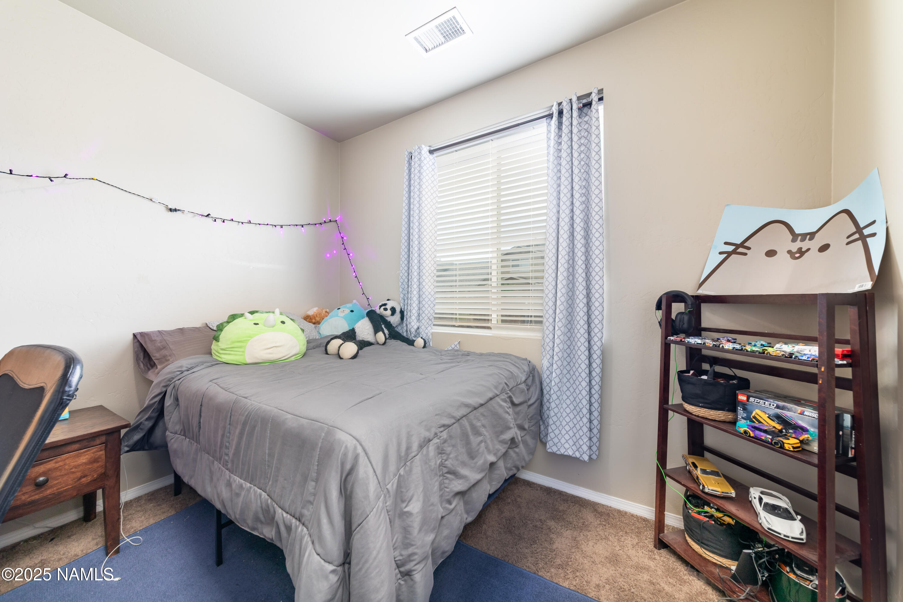 4500 Centaurus Road Bellemont, AZ 86015 - Photo 16 of 20 a bedroom with a bed a book shelf and a window