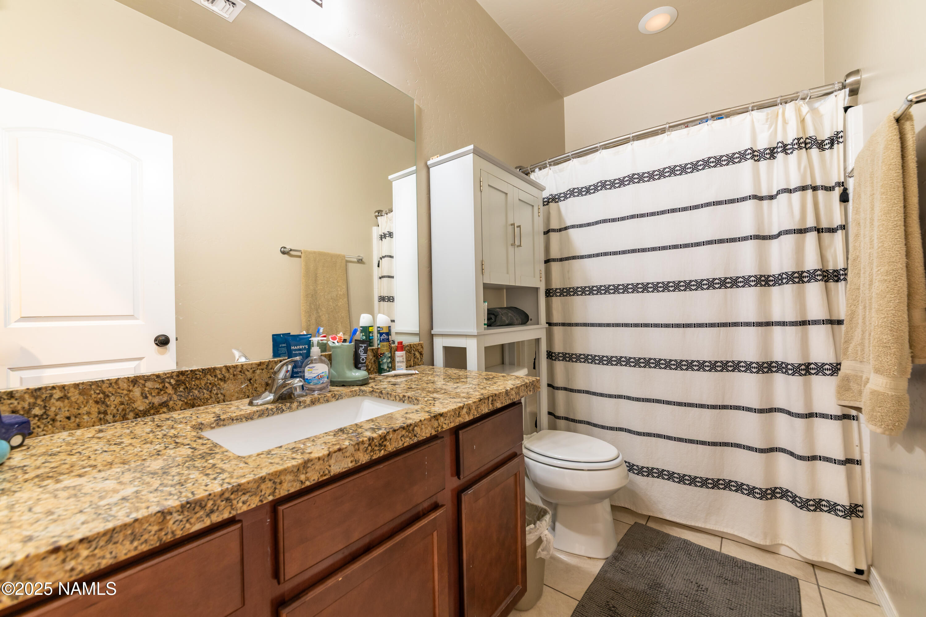 4500 Centaurus Road Bellemont, AZ 86015 - Photo 17 of 20 a bathroom with a granite countertop sink a toilet and shower