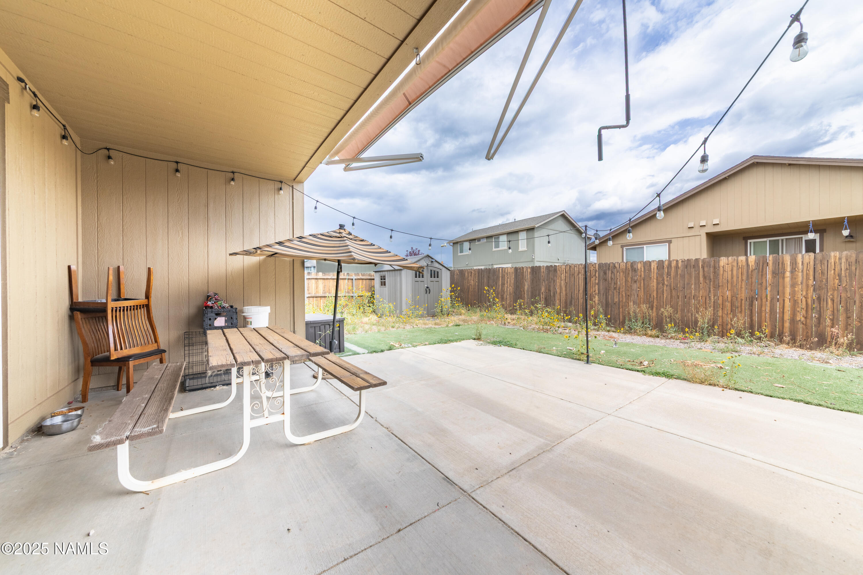 4500 Centaurus Road Bellemont, AZ 86015 - Photo 18 of 20 a view of a patio with table and chairs and wooden fence