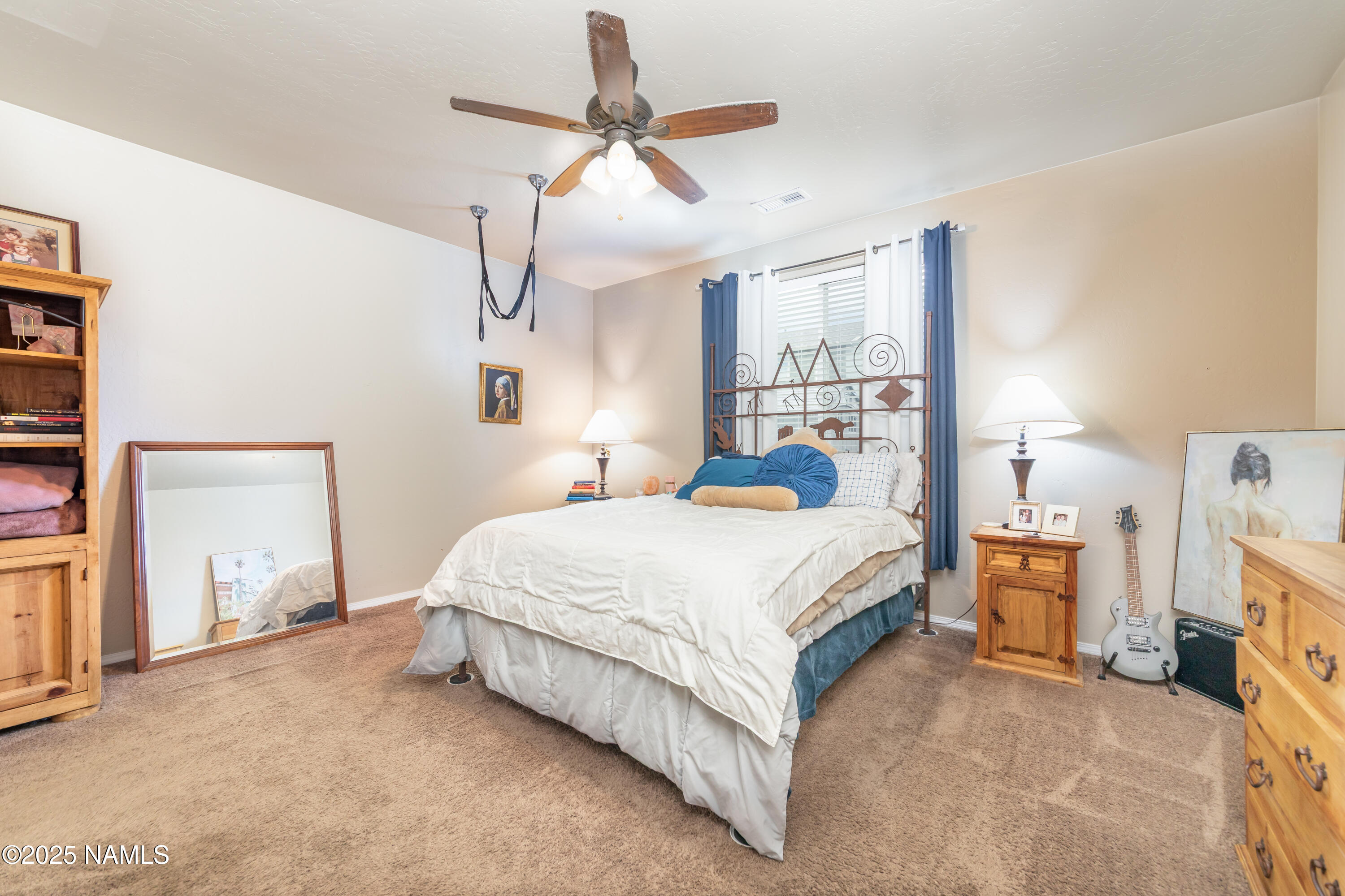 4500 Centaurus Road Bellemont, AZ 86015 - Photo 9 of 20 a bedroom with a bed and a chandelier