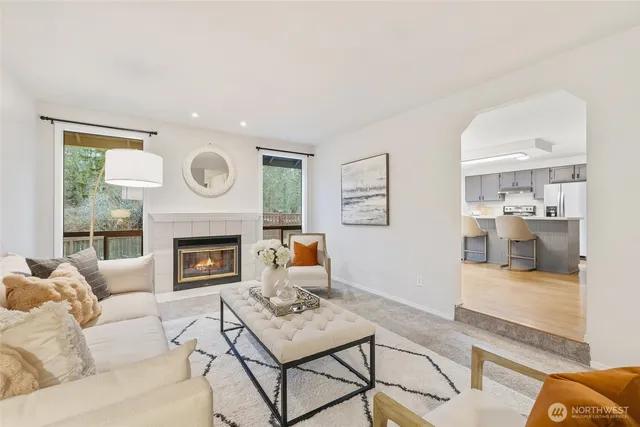 a living room with furniture a clock and a fireplace