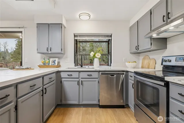 a kitchen with granite countertop white cabinets and white appliances