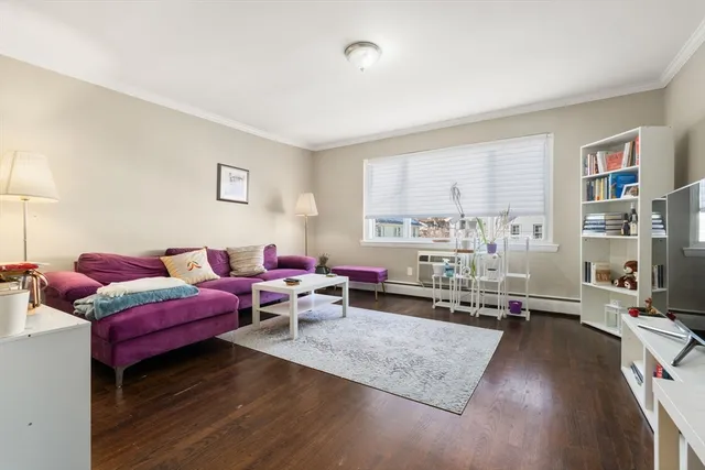a living room with furniture window and wooden floor