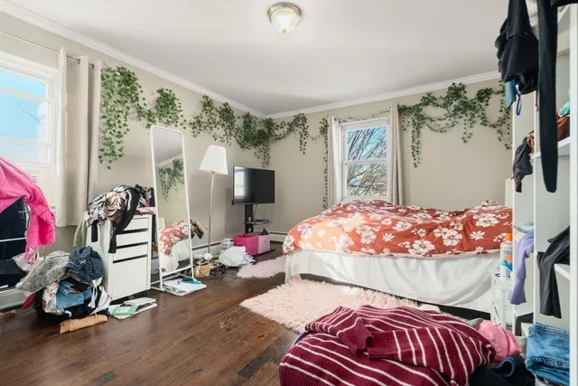 a bedroom with a bed and a flat tv screen