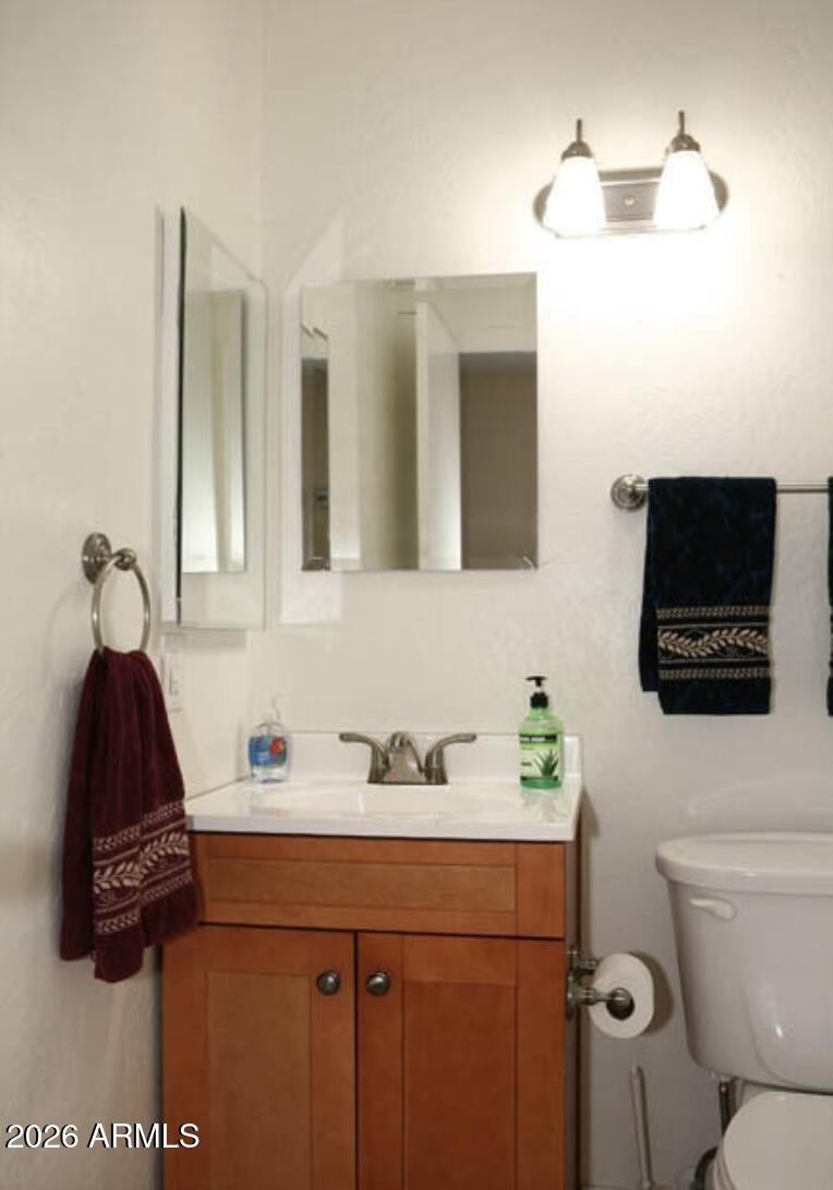 911 West Colgate Drive Tempe, AZ 85283 - Photo 14 of 15 a bathroom with a sink a light fixture and a toilet
