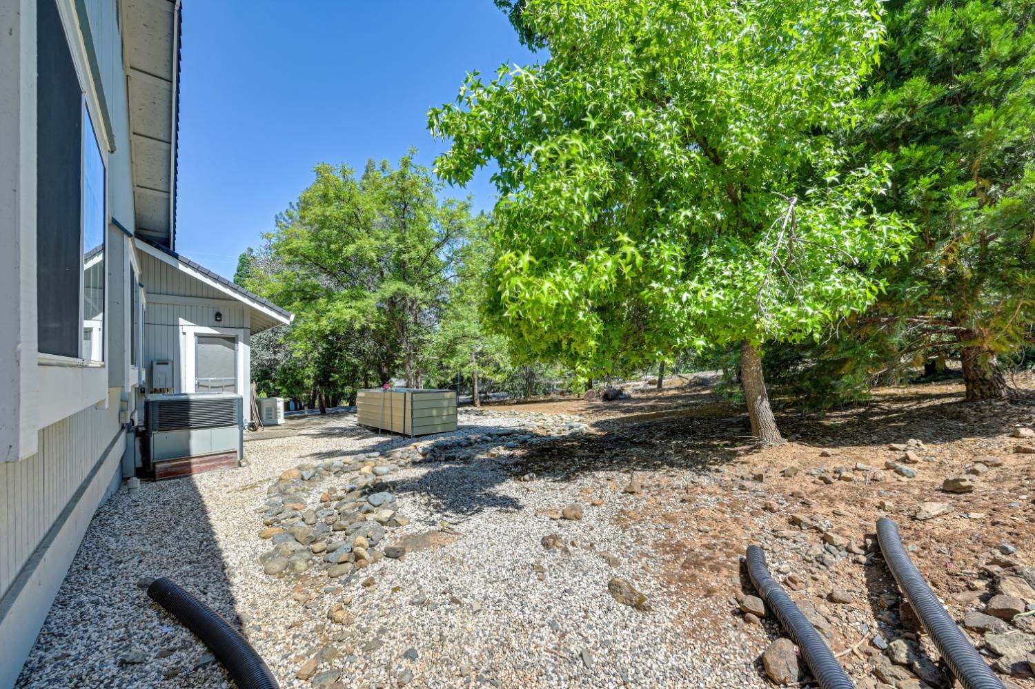22803 Sunset Ridge Drive Auburn, CA 95602 - Photo 34 of 60 Side yard with enclosed propane and Generac generator.