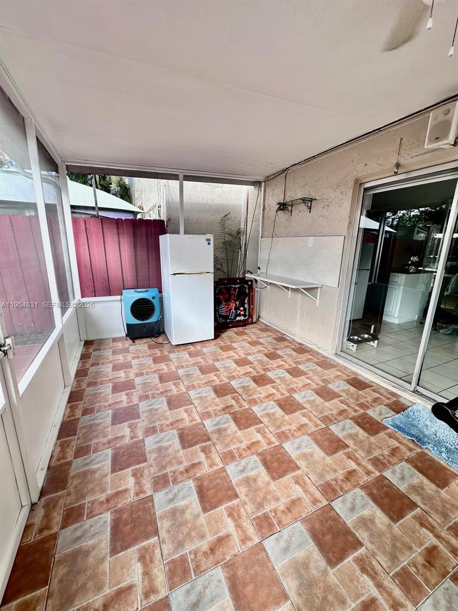 15645 Southwest 82nd Cir Lane, Unit 75 Miami, FL 33193 - Photo 11 of 20 a room with a bed and a black white checkered floor