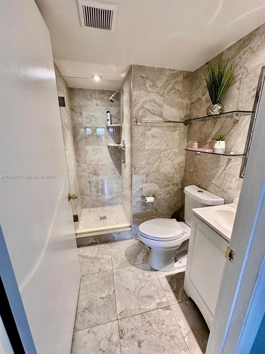 15645 Southwest 82nd Cir Lane, Unit 75 Miami, FL 33193 - Photo 16 of 20 a bathroom with a toilet and a shower