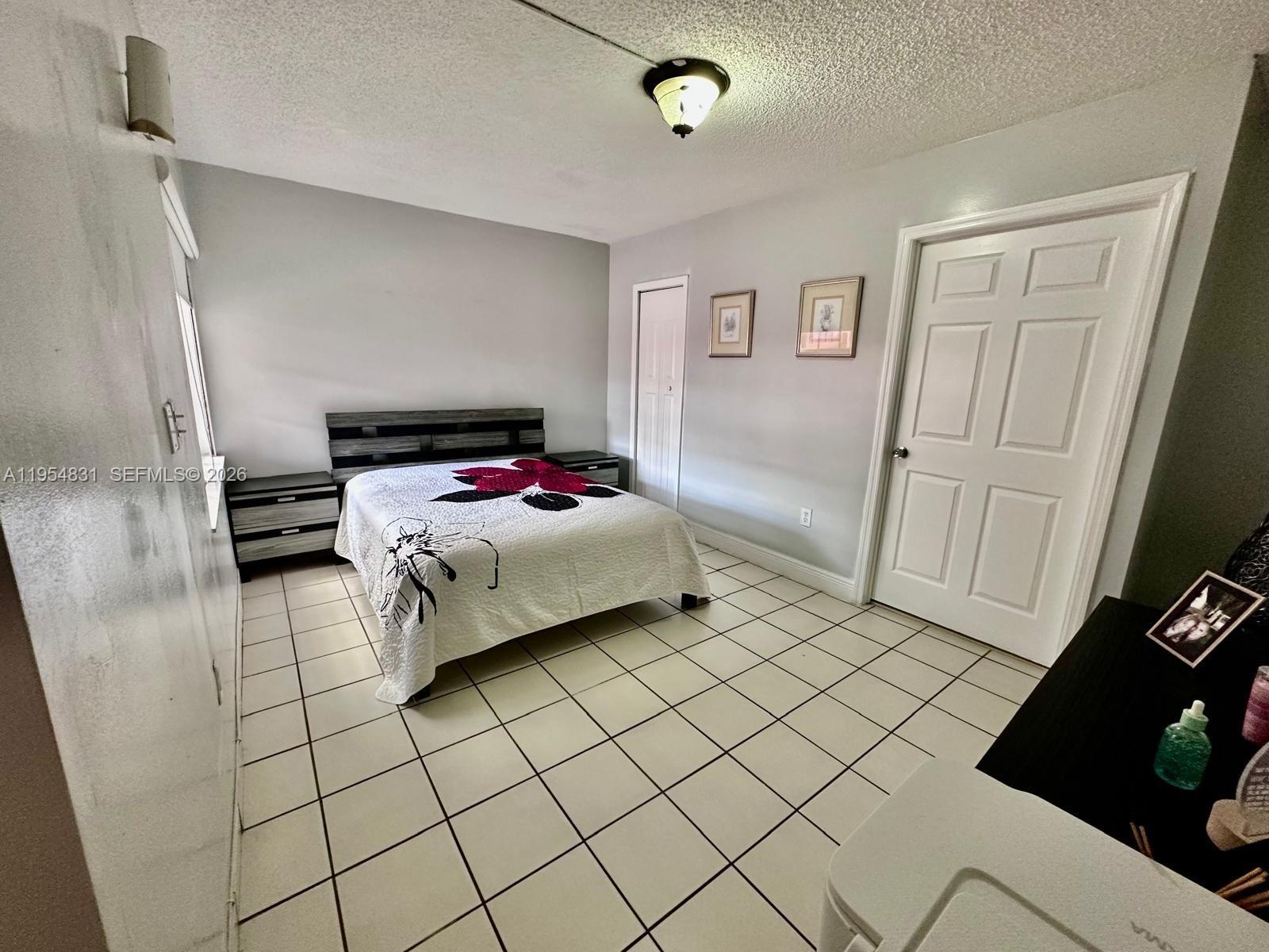 15645 Southwest 82nd Cir Lane, Unit 75 Miami, FL 33193 - Photo 17 of 20 a bedroom with a bed and a window