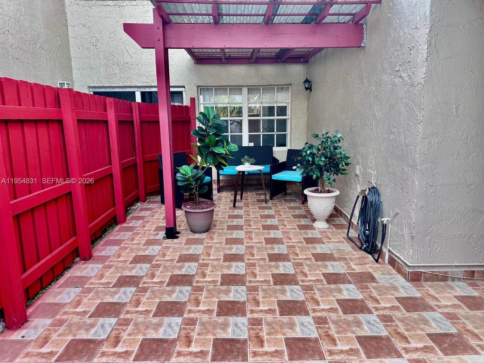 15645 Southwest 82nd Cir Lane, Unit 75 Miami, FL 33193 - Photo 3 of 20 a view of a with a chairs and table in a patio