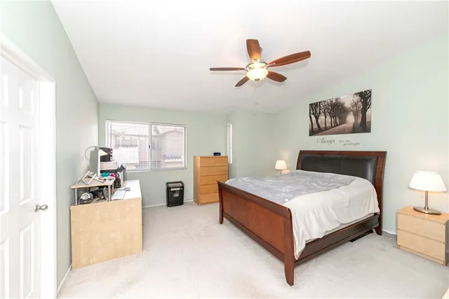 a spacious bedroom with a bed and a chandelier
