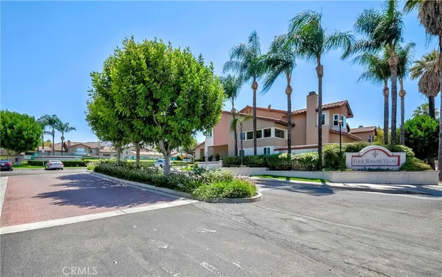 a front view of multiple houses with yard