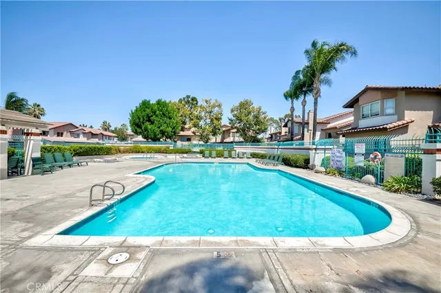 a view of a swimming pool with an outdoor space and seating area